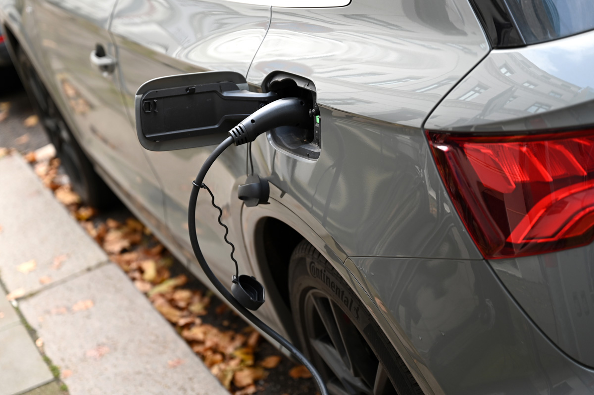 Electric car with charger plugged in