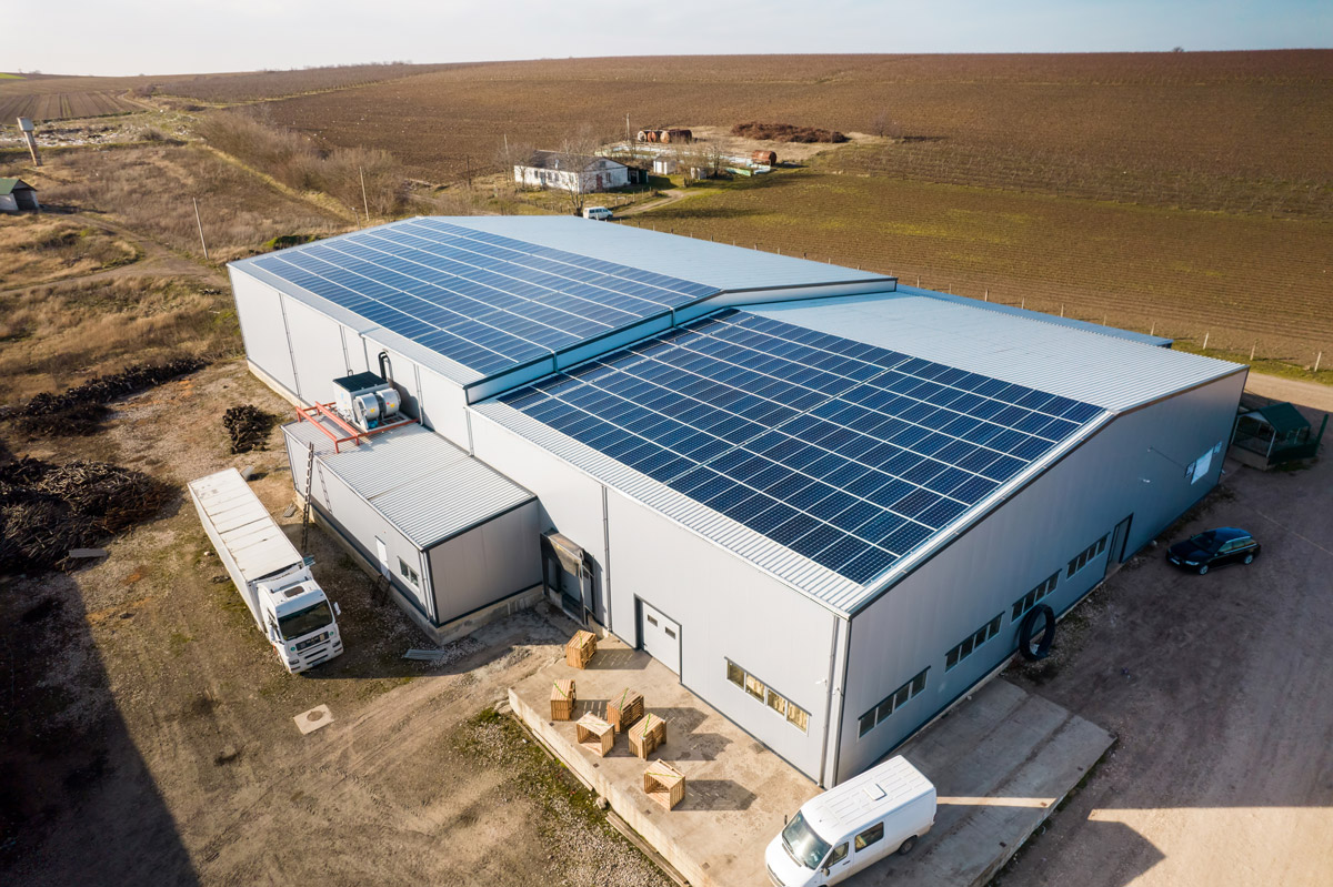 Aerial view of solar panels on roof of commercial manufacturing building